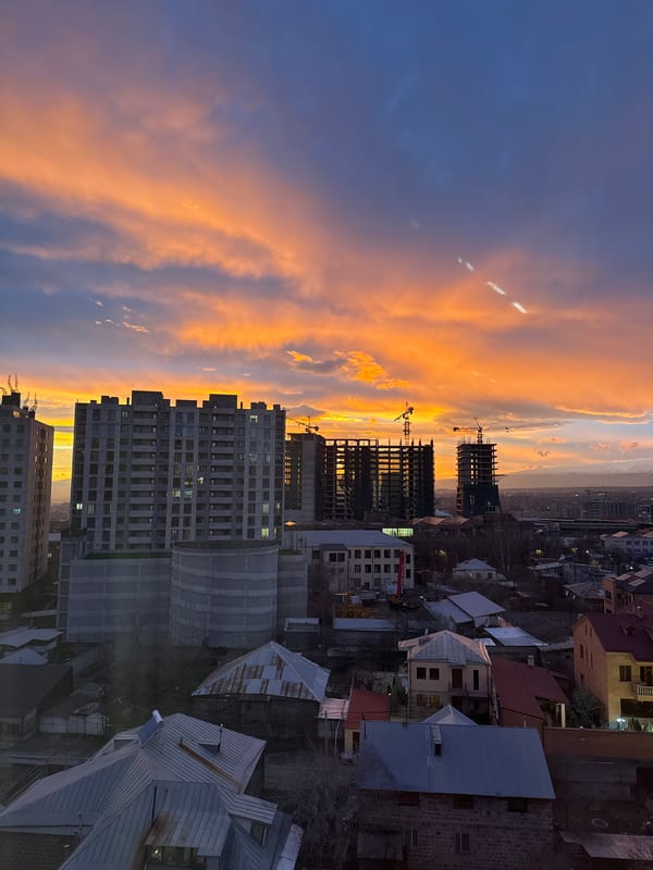Vibrant sunset captured over Yerevan cityscape during twilight hours