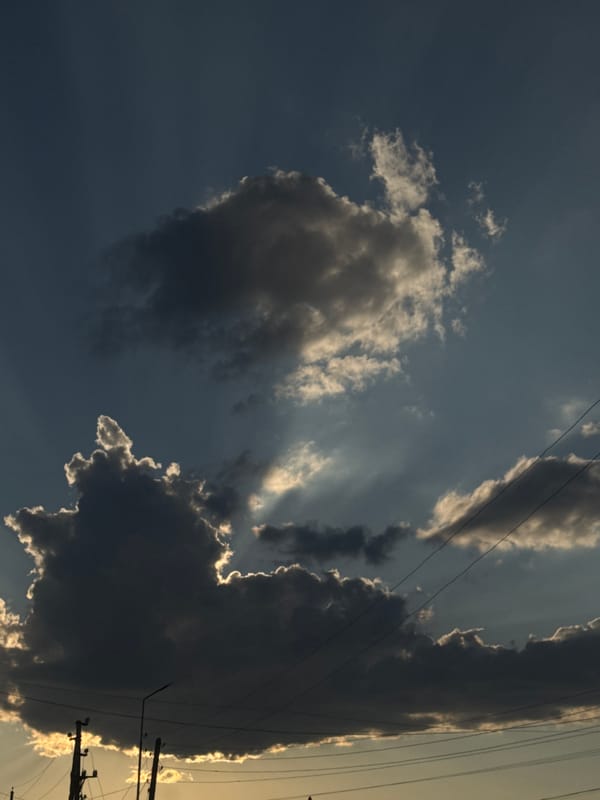 Stormy sunset sky breaks open over Bökönbaev, Kyrgyzstan