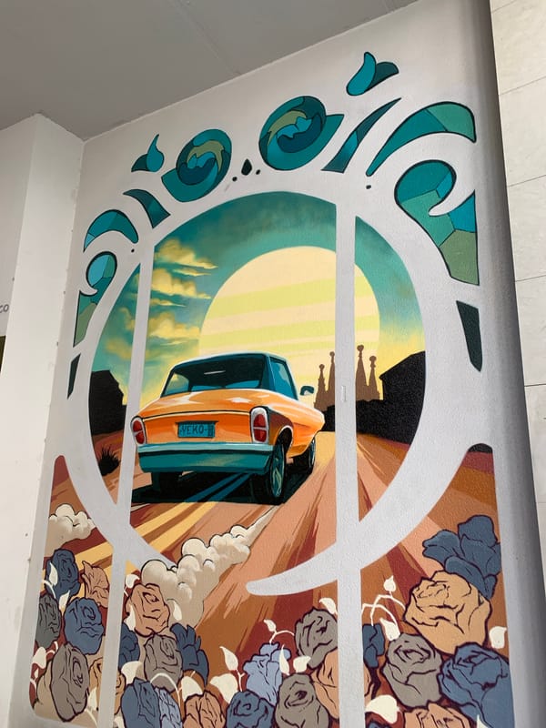 Orange car mural depicts departure from Barcelona cityscape