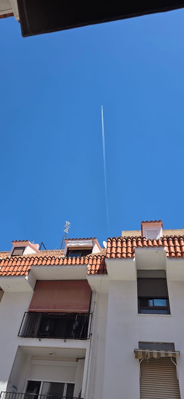 Aircraft leaves contrail over clear skies in Sagunto, Spain