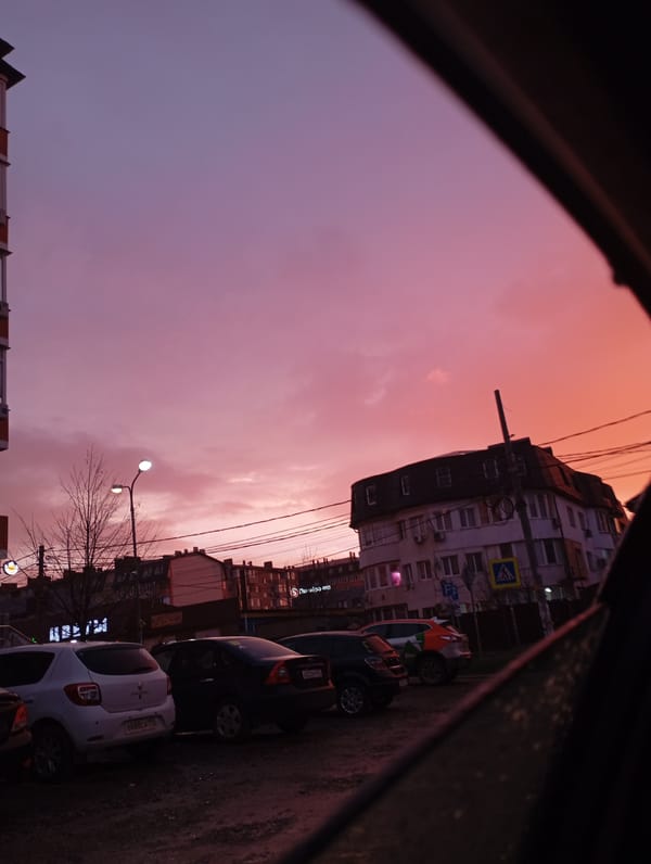 Vehicle occupant documents rainy street scenes in Krasnodar