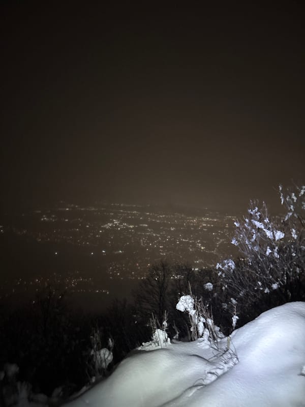 Snowy nighttime city view captured from elevated Sofia location