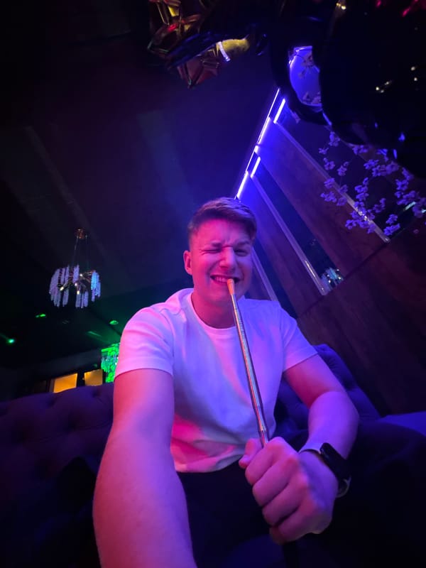 Person enjoys hookah at neon-lit nightclub in Burgas, Bulgaria