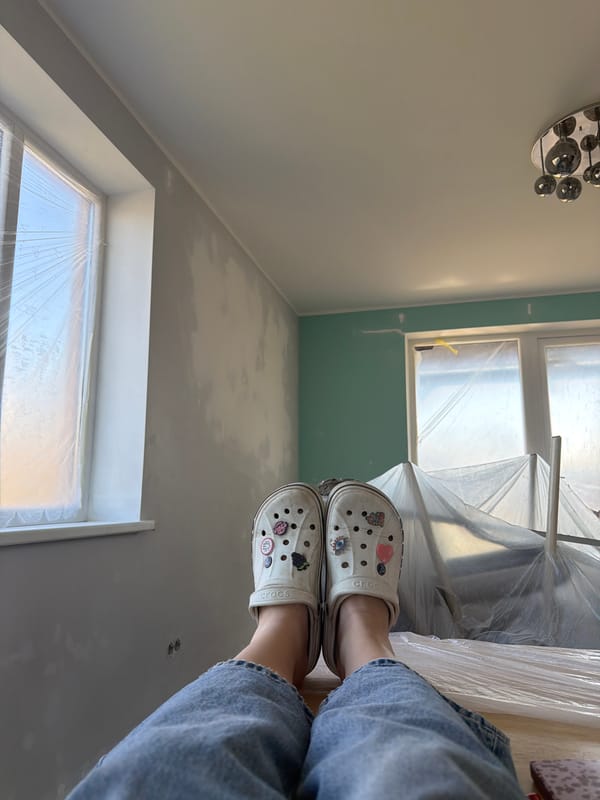 Person in Crocs stands in renovation site in Latvia