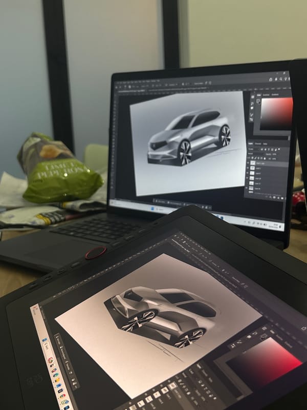 Digital car design work captured on dual screens in Turin