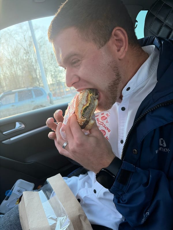 Man eats hamburger in car in Votkinsk, Russia