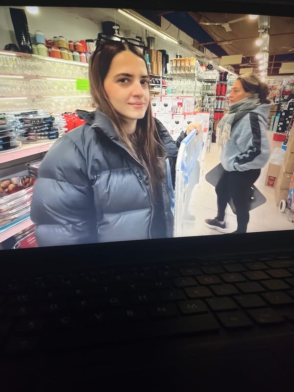 Person documents laptop screen content in Venezuelan home