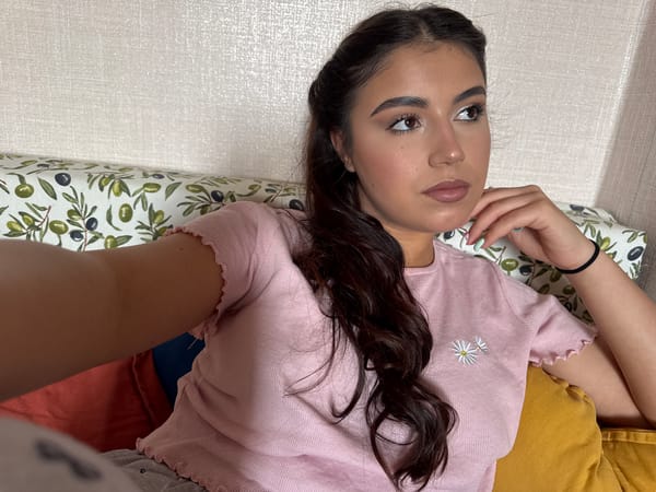 Woman rests on patterned cushions indoors in Sofia
