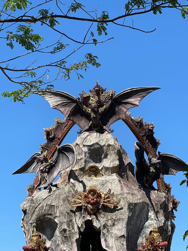 Dragon sculptures and mythical stonework at Dawan's Dewa Citra Shrine