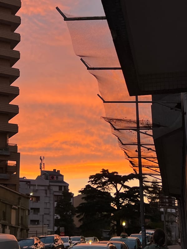 Vibrant sunset with crescent moon observed across Porto, Portugal