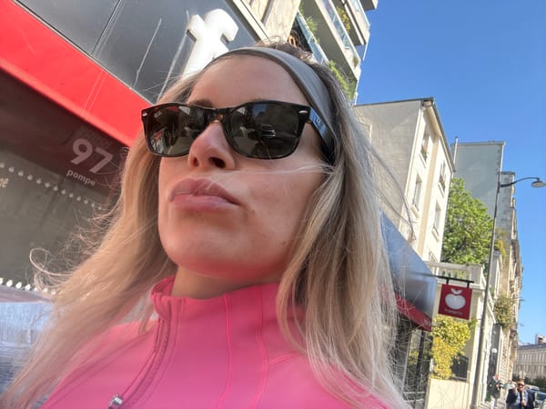 Person takes sunny selfies in Paris urban setting