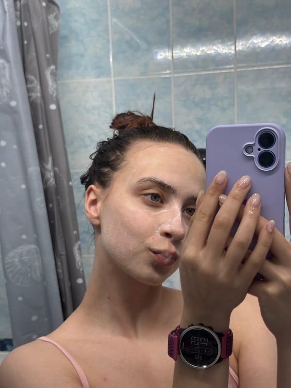 Woman documents morning skincare routine in Russian bathroom