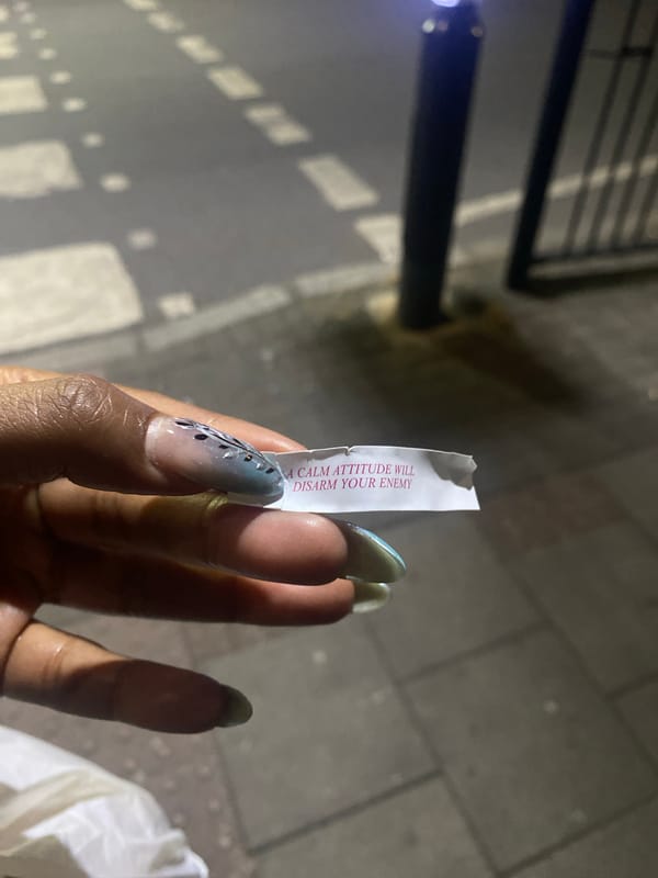 Person reads fortune cookie message in London