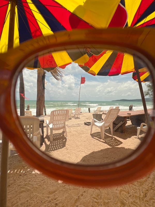 Lazy beach day under striped umbrellas with turquoise water views