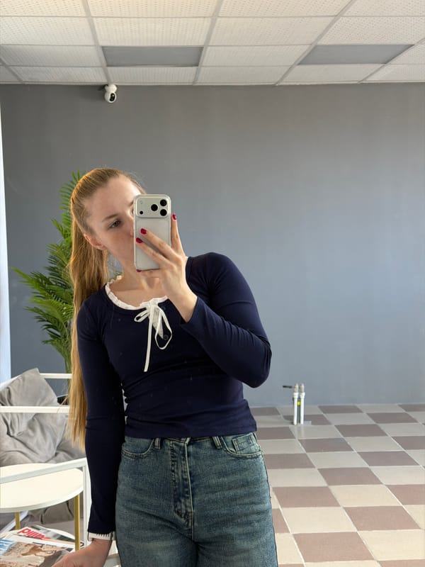 Woman takes multiple mirror selfies in Berezniki office space