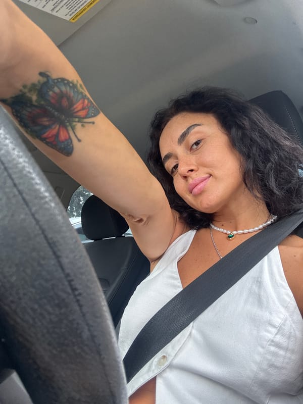 Car selfie series in Tbilisi, pearl necklace and green pendant