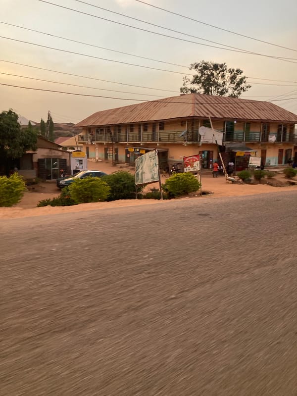 Moving vehicle captures street scene in Jos, Nigeria