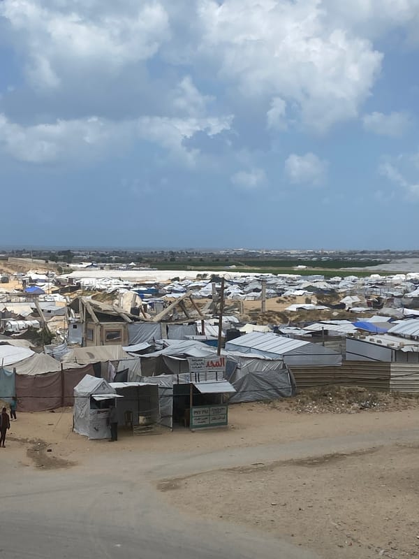 Refugee camp with makeshift shelters documented at unknown location