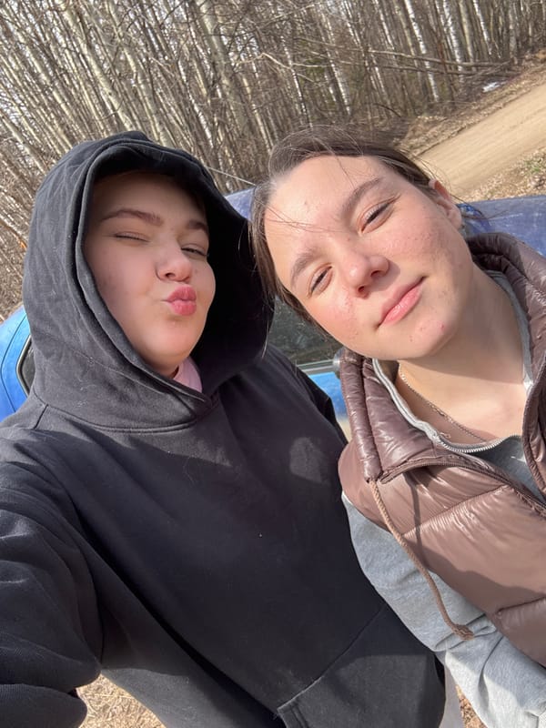 Two women observe spring pussy willows in Chernushka, Russia