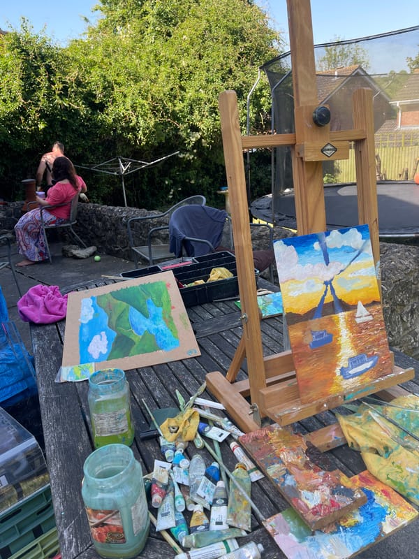 Artist paints boats outdoors while gardener trims bushes in Maidstone