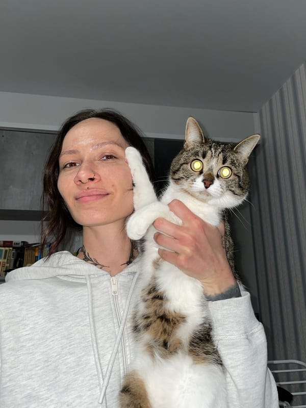 Woman holds cat indoors in Izhevsk, Russia