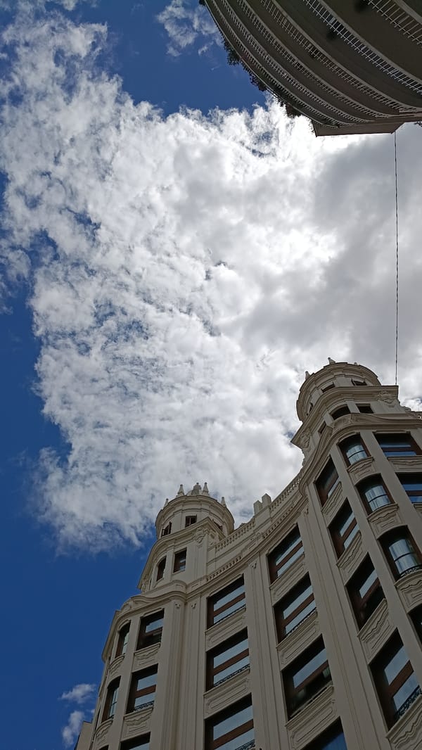 Valencia street scenes captured including ornate building and graffitied storefront