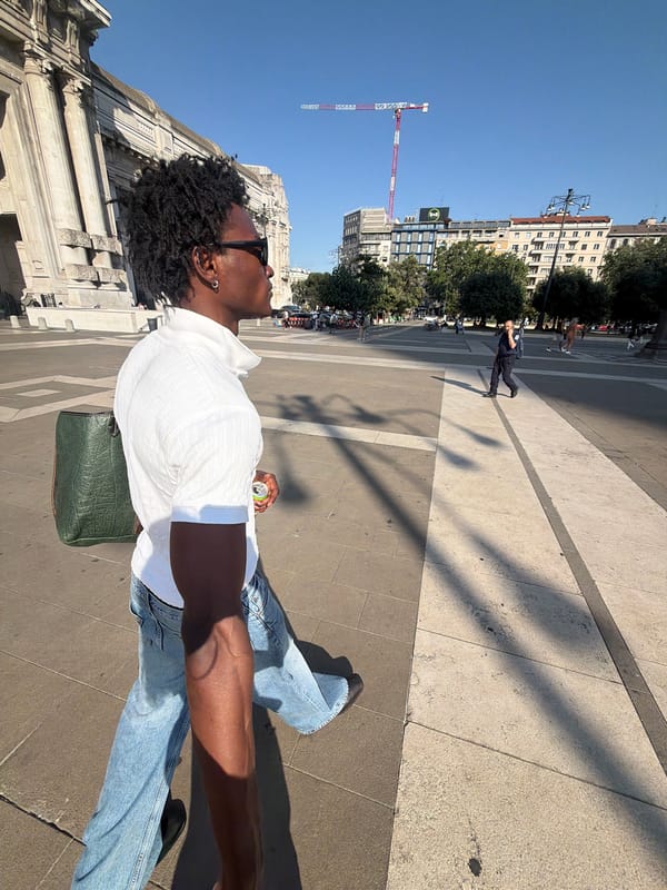 Strolling through a Milan piazza on a bright afternoon.