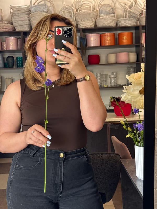 Mirror selfies with purple bellflowers in a retail store