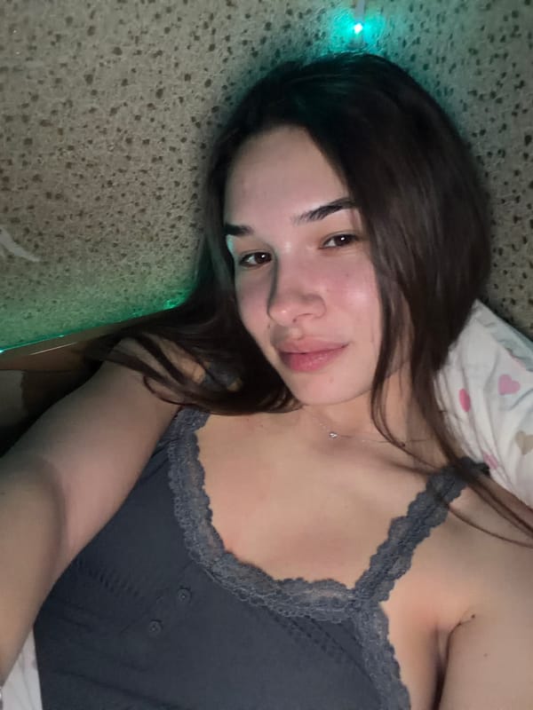 Woman takes mirror selfies in black Guess shirt, Sofia