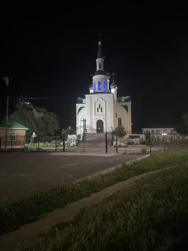 Orthodox church glows at night in Yegorlykskaya, Russia