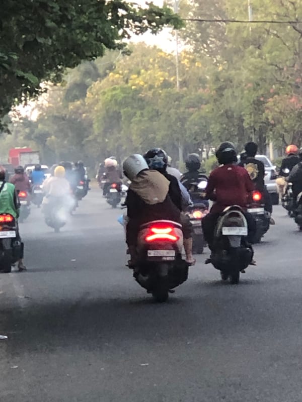 Heavy motorcycle and mixed traffic flows through Sumorame, Indonesia