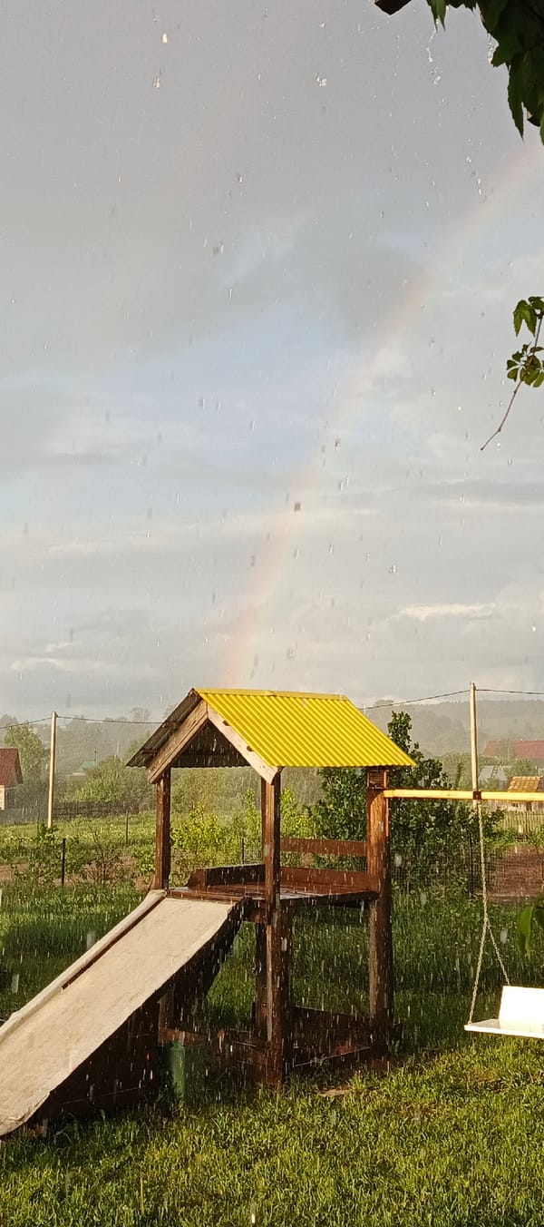 Rainbow appears during heavy rainstorm in Russian village