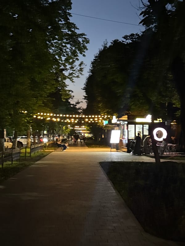 Nighttime stroll along a lit walkway in Khasavyurt