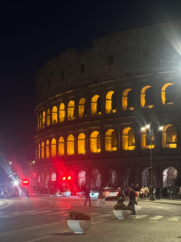 Rome's Colosseum illuminated in golden lights at night
