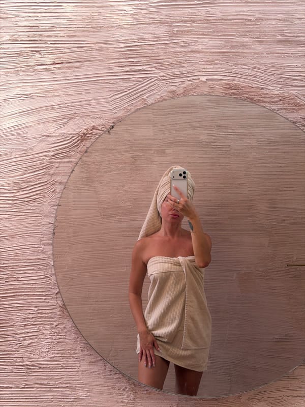 Woman takes towel selfie in mirror, North Kuta Indonesia