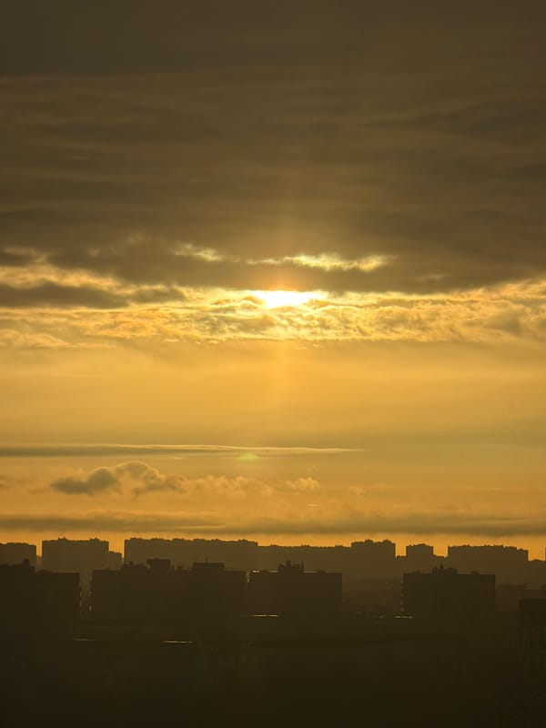 Sunset captured over Saint Petersburg skyline amid cloudy skies