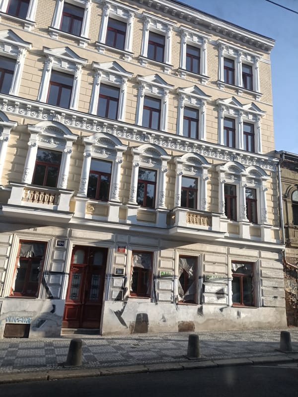 Central Prague streets: trams, ornate facades, and a wall mural