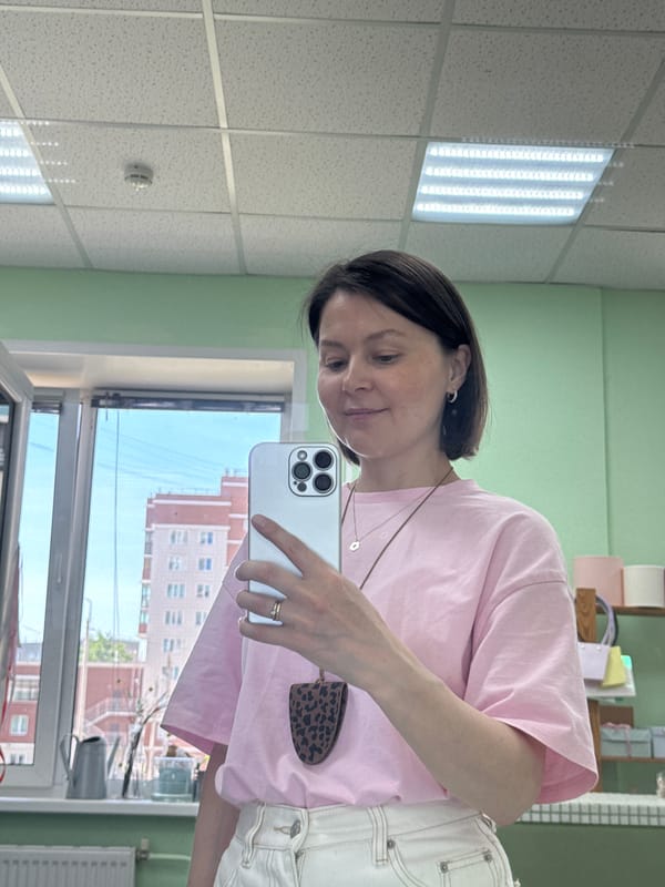 Woman takes selfies in Izhevsk room with green walls