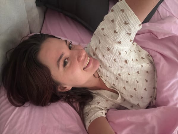 Morning bedroom scene with young woman and cat in Belgrade