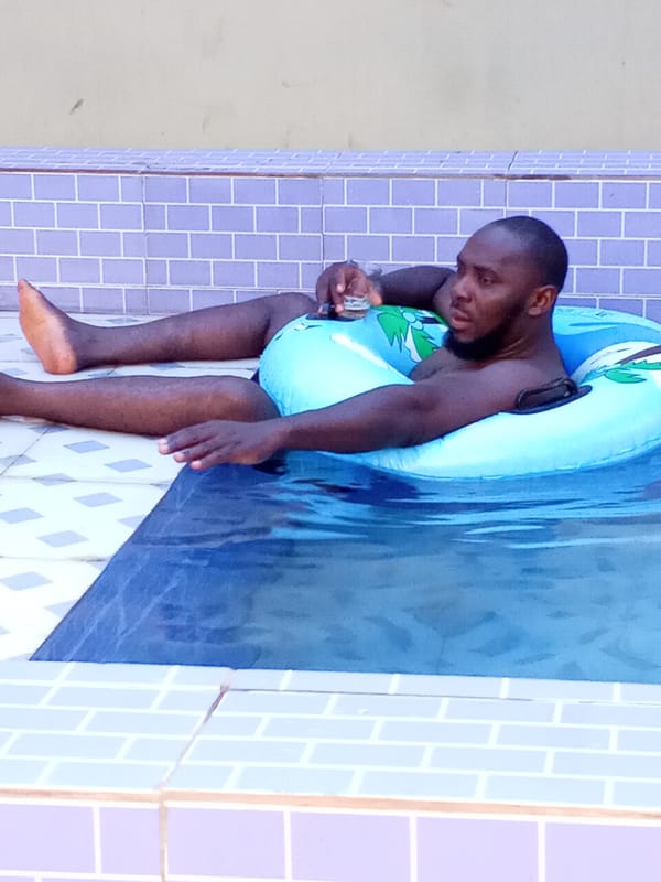 Men relax in swimming pool in Ankpa, Nigeria