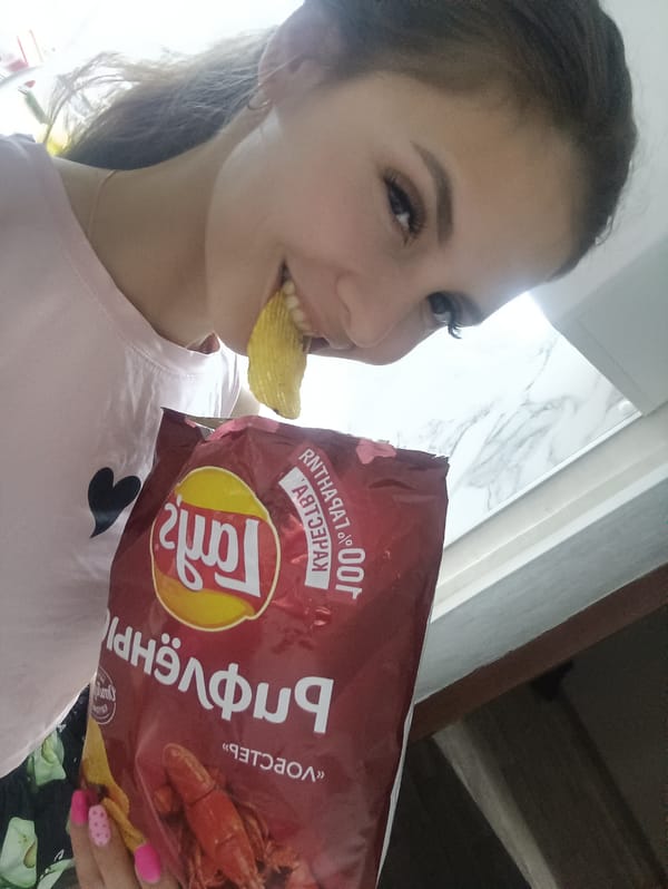 Woman snacks on seafood-flavored potato chips
