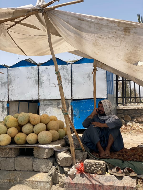 Kandahar street life: vendors, foot traffic, and open road