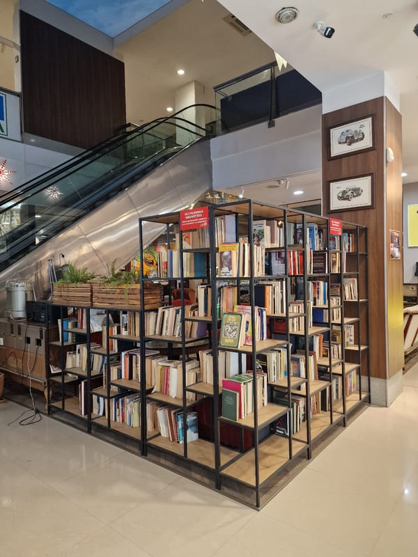 Vintage radio and tiered bookshelves in a quiet interior setting