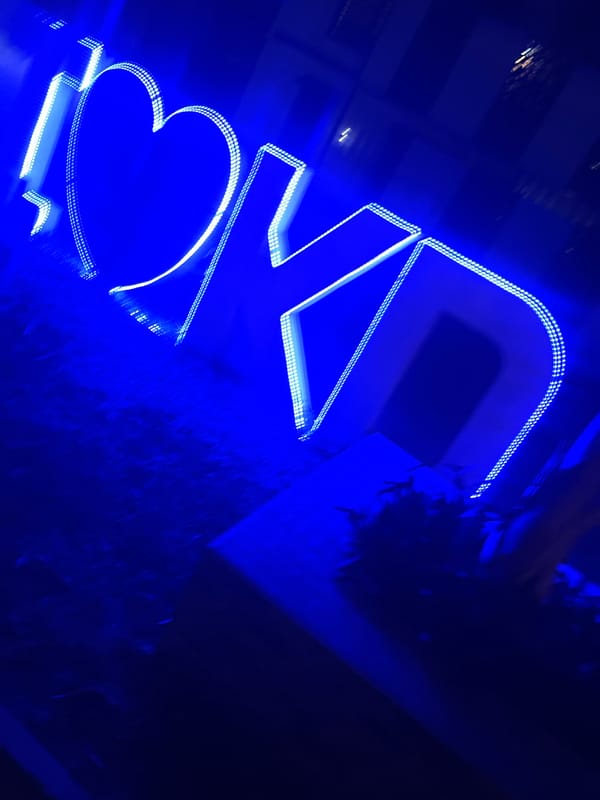 Blue neon heart sign and soccer field activity observed