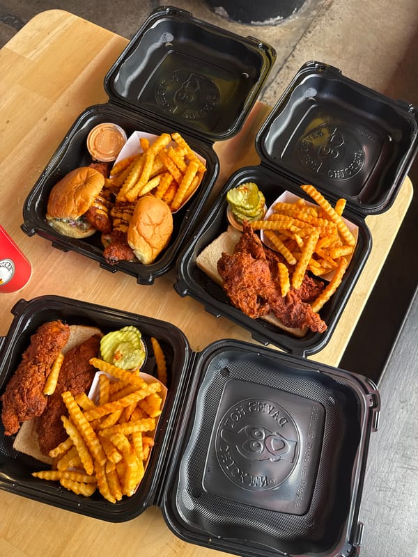 Takeout chicken meals photographed in San Diego dining setup