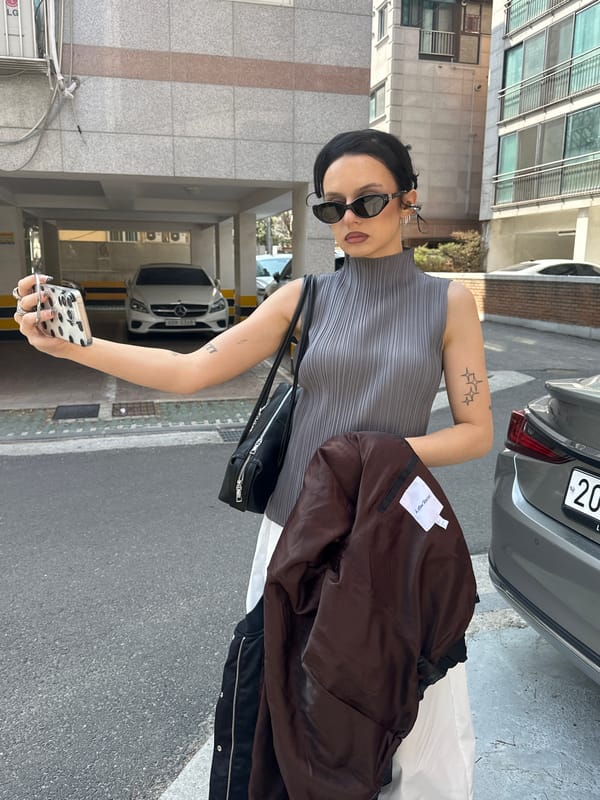 Woman takes selfies on Seoul street during early morning