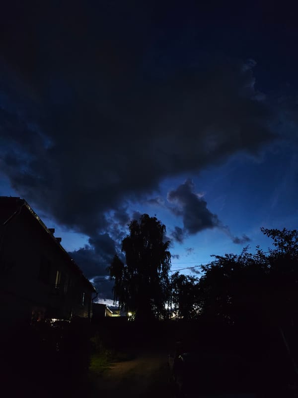 Suburban house silhouetted against a moody twilight sky