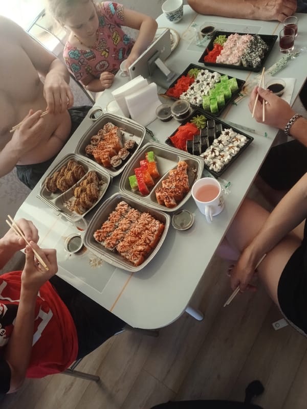 Big sushi spread shared around a well-stocked table