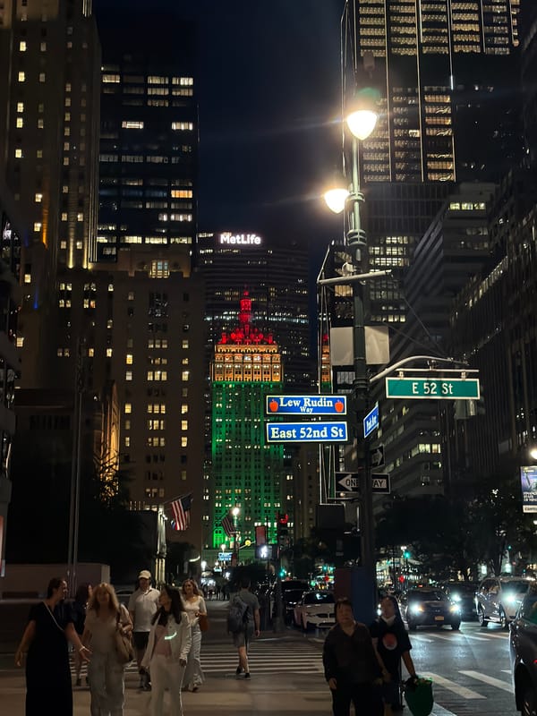 Midtown Manhattan intersection glowing after midnight