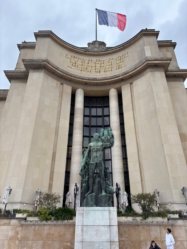Tourists gather at Eiffel Tower Olympic rings display